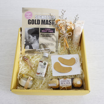 sweet skincare and chocolate gift set 	A gift set with a facial kit, eye care pads, hand cream, a selection of different chocolates, a candle, some matches and some flowers.