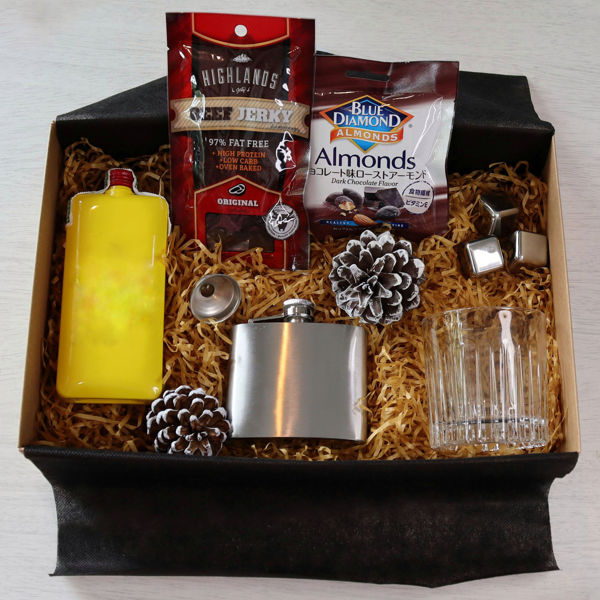 Scotch whisky gift box with a bottle of J&B scotch, a hip flask, drinking glass, metal ice cubes & snacks