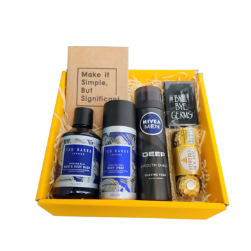 The Sweet & Clean Sterling Shave Gift Set A gift box for men with a Gillette razor and aftershave set, Tom Baker body wash and spray, cotton buds with a storage box and some Lindt Lindor dark chocolates.